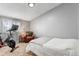This well-lit bedroom features neutral tones, an exercise bike and an accent chair at 1244 S Reed St # 2, Lakewood, CO 80232