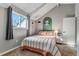 Cozy bedroom with a sloped ceiling, a window, and a shelf in an accent painted archway at 1244 S Reed St # 2, Lakewood, CO 80232