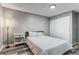 This cozy bedroom features gray walls, wood-look floors, and a double-door closet at 1244 S Reed St # 2, Lakewood, CO 80232