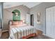 Cozy bedroom with pitched ceiling and charming decor, including a full length mirror at 1244 S Reed St # 2, Lakewood, CO 80232