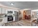 Well-lit kitchen with stainless steel appliances, granite countertops, and a dining area at 1244 S Reed St # 2, Lakewood, CO 80232