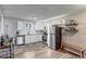 Well-lit kitchen with white cabinets, stainless appliances, and wood-look flooring at 1244 S Reed St # 2, Lakewood, CO 80232
