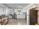 Modern kitchen with stainless steel appliances, white cabinets, and ample counter space at 1244 S Reed St # 2, Lakewood, CO 80232