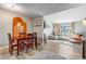 Open-concept living space flows between dining area and living room with fireplace at 1244 S Reed St # 2, Lakewood, CO 80232