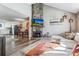 Inviting living room features a stone fireplace and views of kitchen and dining area at 1244 S Reed St # 2, Lakewood, CO 80232