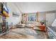 Comfortable living room with a stone fireplace, large window, and stylish decor at 1244 S Reed St # 2, Lakewood, CO 80232