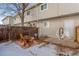 Back patio with wooden fence, chairs, and room to relax in your backyard at 1244 S Reed St # 2, Lakewood, CO 80232