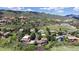 Wide aerial view of houses in a community in a rural landscape with a mountain backdrop at 7084 Fox Paw Trl, Littleton, CO 80125