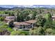 Aerial of suburban homes surrounded by lush mature trees and landscaped yards in a hillside neighborhood at 7084 Fox Paw Trl, Littleton, CO 80125