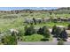 Aerial view of a quiet neighborhood with a two-story home surrounded by mature trees and lawns at 7084 Fox Paw Trl, Littleton, CO 80125