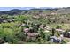 Wide aerial view of homes on a hillside and mountains in the distance at 7084 Fox Paw Trl, Littleton, CO 80125