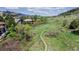 Secluded backyard featuring a winding walking path surrounded by lush greenery and picturesque mountain views at 7084 Fox Paw Trl, Littleton, CO 80125