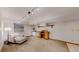 Spacious carpeted basement with a wet bar, work space, and comfortable seating area at 7084 Fox Paw Trl, Littleton, CO 80125