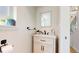 Stylish powder room featuring a vanity with modern finishes, and an eye-catching mirror at 7084 Fox Paw Trl, Littleton, CO 80125