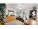 Bright bedroom featuring a ceiling fan, a wooden dresser with a large mirror, plants, and a window with a view at 7084 Fox Paw Trl, Littleton, CO 80125