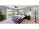 Bright bedroom with a walkout to a balcony with a view, a cozy bed, and stylish decor at 7084 Fox Paw Trl, Littleton, CO 80125
