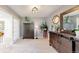 Bedroom featuring gray walls, a dresser, and a mirror, with an adjoining room through double doors at 7084 Fox Paw Trl, Littleton, CO 80125
