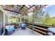 Inviting deck with comfortable seating and a scenic view of the surrounding greenery at 7084 Fox Paw Trl, Littleton, CO 80125