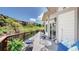 View of a deck with seating, overlooking a grassy hillside and neighborhood homes on a sunny day at 7084 Fox Paw Trl, Littleton, CO 80125