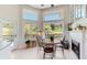 Inviting dining area filled with natural light, a fireplace, and views of the outdoors at 7084 Fox Paw Trl, Littleton, CO 80125
