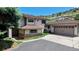 Charming home with a two-car garage, mature trees, and a well-maintained lawn at 7084 Fox Paw Trl, Littleton, CO 80125