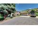 Shot of a two-story home with stone accents, an attached garage, and driveway with a parked car at 7084 Fox Paw Trl, Littleton, CO 80125