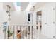 Bright hallway featuring modern light fixtures, skylights, and decorative railing at 7084 Fox Paw Trl, Littleton, CO 80125