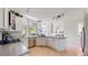 Open concept kitchen features stainless appliances, granite counter tops and bar seating at 7084 Fox Paw Trl, Littleton, CO 80125