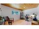 Bright, light filled office with wooden floors, light walls and a large window at 7084 Fox Paw Trl, Littleton, CO 80125