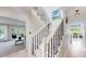 Open staircase with neutral finishes and black metal railings, providing great natural light at 7084 Fox Paw Trl, Littleton, CO 80125