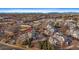An aerial view showcases community, mature trees, and mountain views in the background at 8701 Huron St # 1-207, Thornton, CO 80260