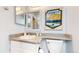 Well-maintained bathroom with a granite vanity, toilet, and decorative elements at 8701 Huron St # 1-207, Thornton, CO 80260