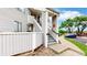 Exterior view of a home featuring a well-maintained yard and stairway at 8701 Huron St # 1-207, Thornton, CO 80260