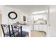 Bright kitchen with granite countertops and white appliances, adjacent to the living space at 8701 Huron St # 1-207, Thornton, CO 80260