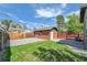 The fenced backyard features a well-maintained lawn and a detached brick building at 1939 S Sherman St, Denver, CO 80210