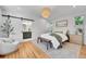 Bright bedroom with a sliding barn door to the ensuite bathroom at 1939 S Sherman St, Denver, CO 80210
