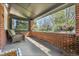 Relaxing covered porch featuring a brick accent wall, comfortable chair, and colorful flowers, perfect for outdoor enjoyment at 1939 S Sherman St, Denver, CO 80210