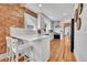 Bright kitchen with white cabinetry, stainless steel appliances, a breakfast bar, and hardwood floors, ideal for cooking at 1939 S Sherman St, Denver, CO 80210