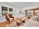 Inviting living room showcases an open layout to the dining area, wood floors, and abundant natural light from large windows at 1939 S Sherman St, Denver, CO 80210