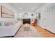 Bright living room with a cozy fireplace, large windows, hardwood floors, and neutral-toned furniture for relaxed living at 1939 S Sherman St, Denver, CO 80210