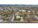 Aerial view of house, highlighted with a yellow arrow, and surrounding neighborhood at 6895 E 74Th Ave, Commerce City, CO 80022
