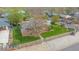 Aerial view of residence displaying meticulous landscaping, fencing, and mature trees at 6895 E 74Th Ave, Commerce City, CO 80022