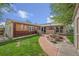 Backyard featuring a stone fire pit, grill, and storage shed in a well-maintained space at 6895 E 74Th Ave, Commerce City, CO 80022