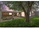 Backyard featuring a stone fire pit, built-in grill, and large tree providing shade at 6895 E 74Th Ave, Commerce City, CO 80022