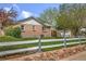 Well-maintained backyard and lawn around a brick home with a white-trimmed roof at 6895 E 74Th Ave, Commerce City, CO 80022
