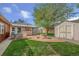 A backyard with a fire pit, shed, grill, and a well-maintained lawn at 6895 E 74Th Ave, Commerce City, CO 80022