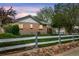 A well-maintained backyard and lawn around a brick home, as seen from behind the fence at 6895 E 74Th Ave, Commerce City, CO 80022