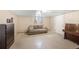 Finished basement includes a couch, storage chest, and piano in a neutral-colored space at 6895 E 74Th Ave, Commerce City, CO 80022