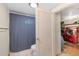 This bathroom features a toilet and a doorway that leads to the home's laundry room at 6895 E 74Th Ave, Commerce City, CO 80022