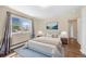 Serene bedroom with hardwood floors, large window, and stylish decor at 6895 E 74Th Ave, Commerce City, CO 80022